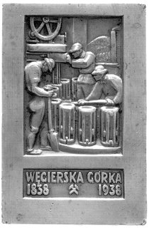 plakieta wybita z okazji stulecia huty w Węgierskiej Górce 1938 r., Aw: Hutnicy przy pracy i napis u dołu: WĘGIERSKA GÓRKA 1838 1938, Rw: Widok huty pod sztandarem z orłem