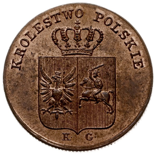 pamiątkowe pudełko z monetami Powstania Listopadowego oklejone ozdobnym papierem koloru zielonego z wytłoczonym złotym napisem 1831 i ozdobną ramką wokół krawędzi pudełka, we wnętrzu pudełka w zagłębieniach monety